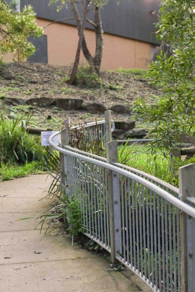 Curved handrail beside a path