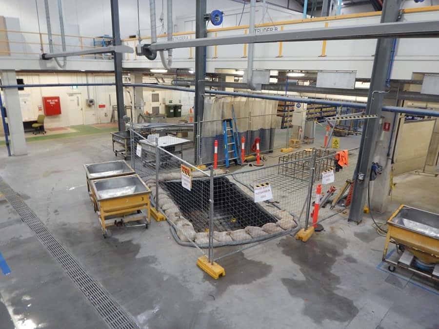 Industrial concrete works beside factory equipment