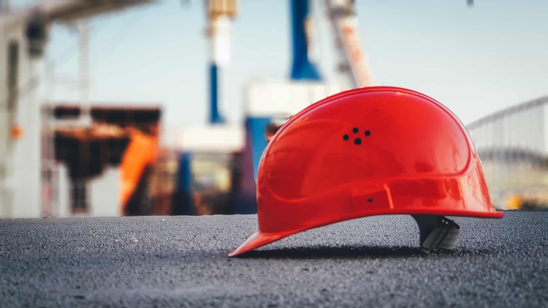 Red safety helmet on construction site