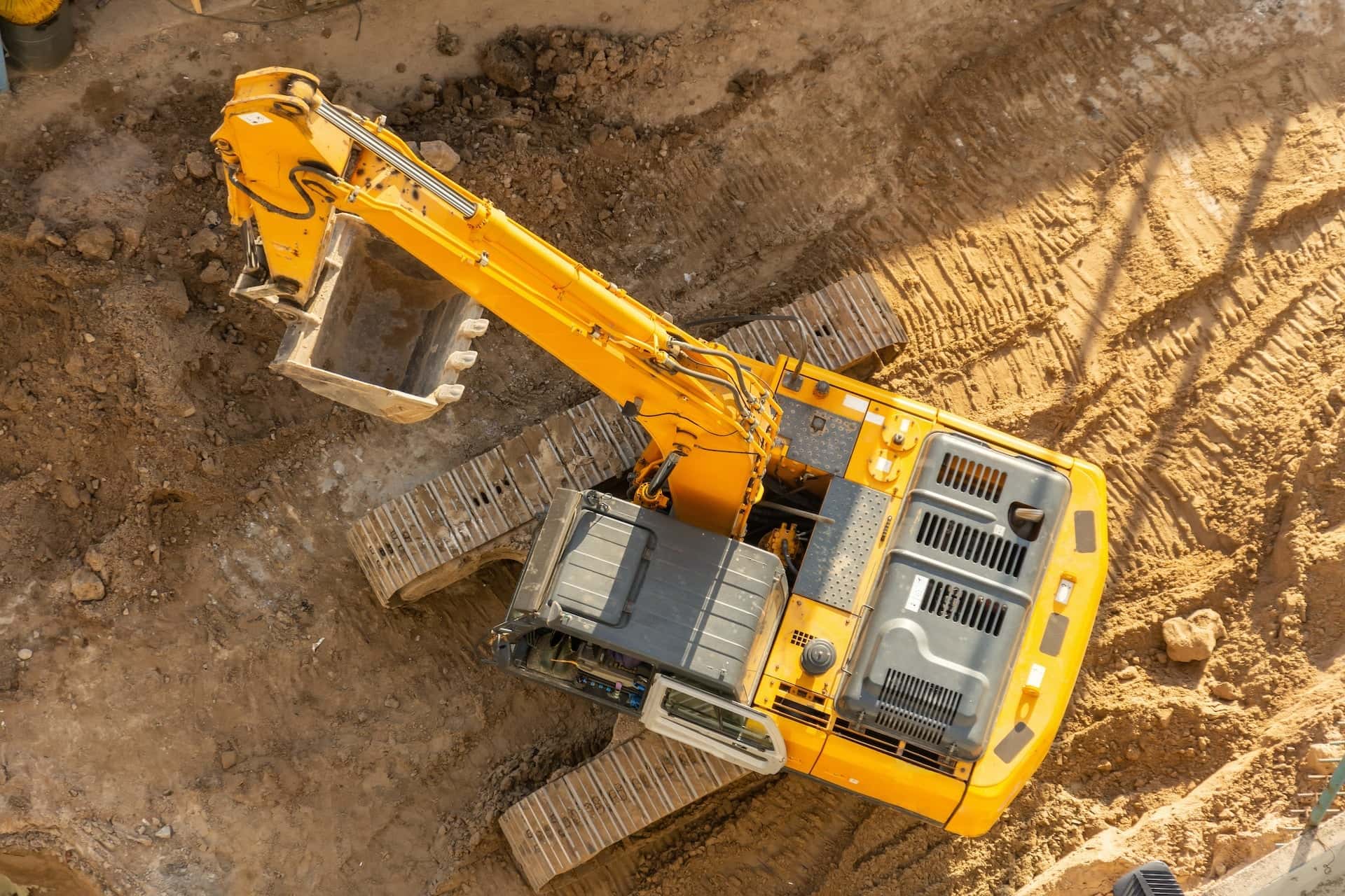 Yellow excavator digging dirt