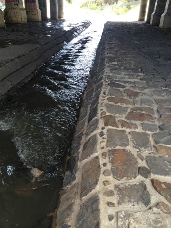 Water flowing under bridge