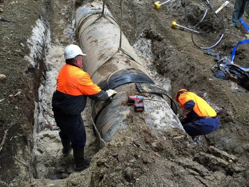 Construction crew working on pipe